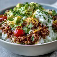Hearty Turkey Taco Bowl with seasoned ground turkey, fluffy rice, fresh avocado, and cheese.
